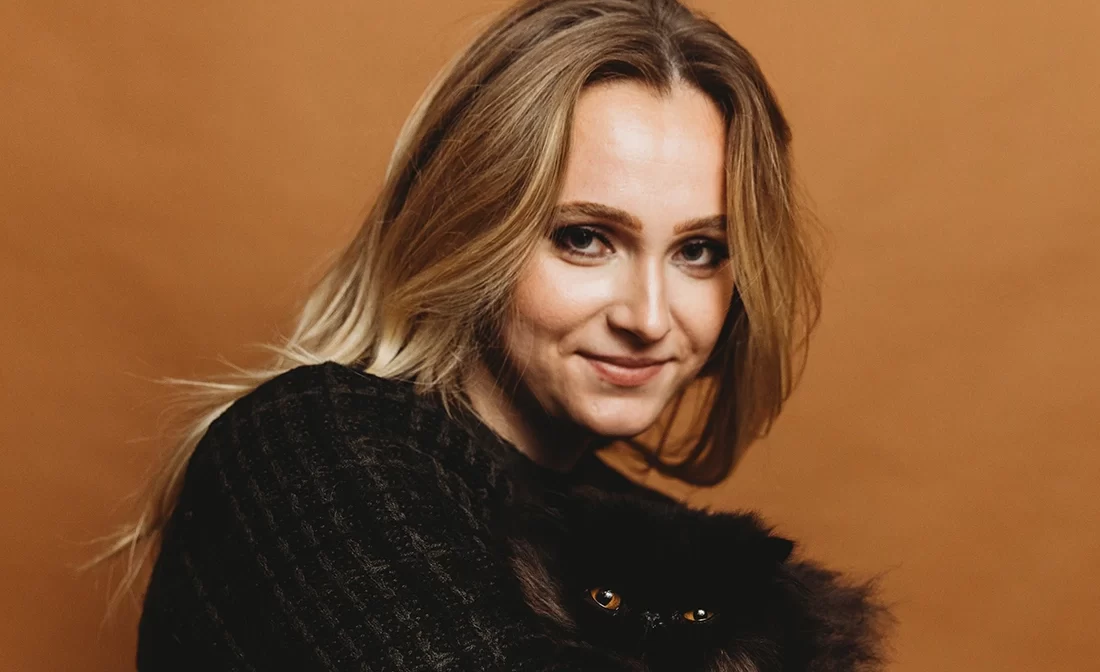 Portrait of Emily Sulkanen with her cat. Emily is a Graphic Designer at 2Shea Creative.