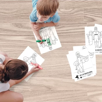 Photo of children using crayons to color black and white illustrations of human's with super human powers as part of the Be A 30 Minute Hero campaign.